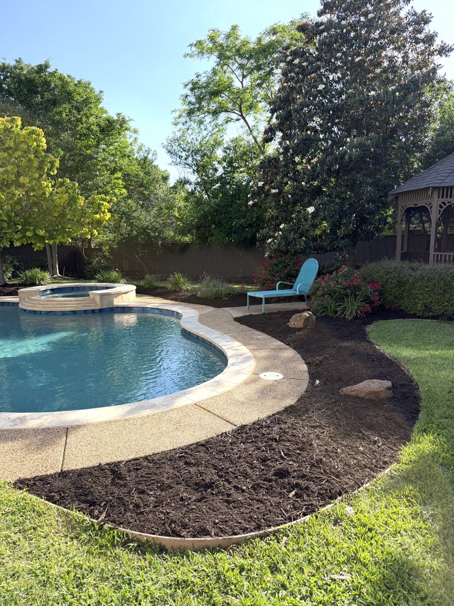 Pool patio with newly edged and mulched landscape bed and gazebo